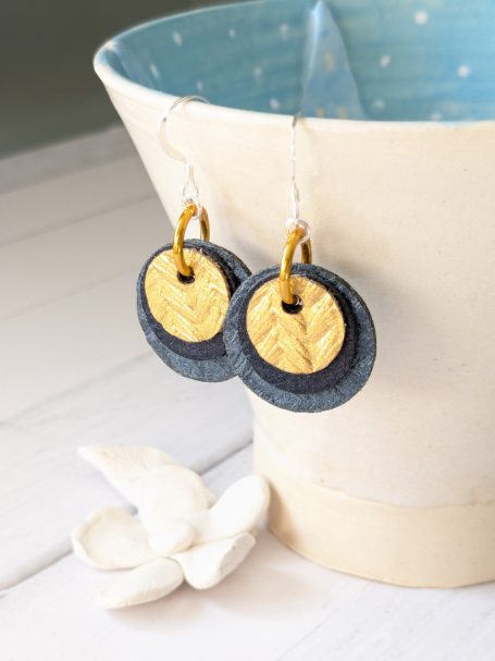 Navy & Gold Vegan Earrings – Pintex, Sterling Silver, Handmade by Amanda Cope Vegan earrings made from Pintex in navy and gold, featuring round circles, sterling silver ear hooks, and gold anodised aluminium.