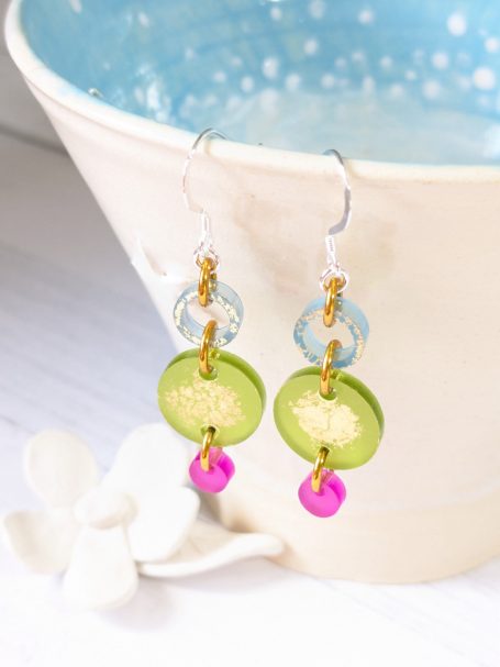 Blue, Olive & Pink Drop Earrings – Sustainable Eco-Friendly Acrylic, Handmade by Amanda and Graham Cope Handcrafted earrings with a blue hollow circle, olive green disc, and pink drop, made from sustainable, recyclable acrylic. Approx. 3.8 cm
